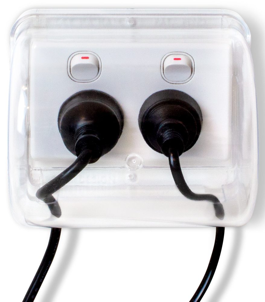 The Micky Ha Ha Power Point Safety Cover seen from the front, clear and fitted over a double power point with two plugs inside